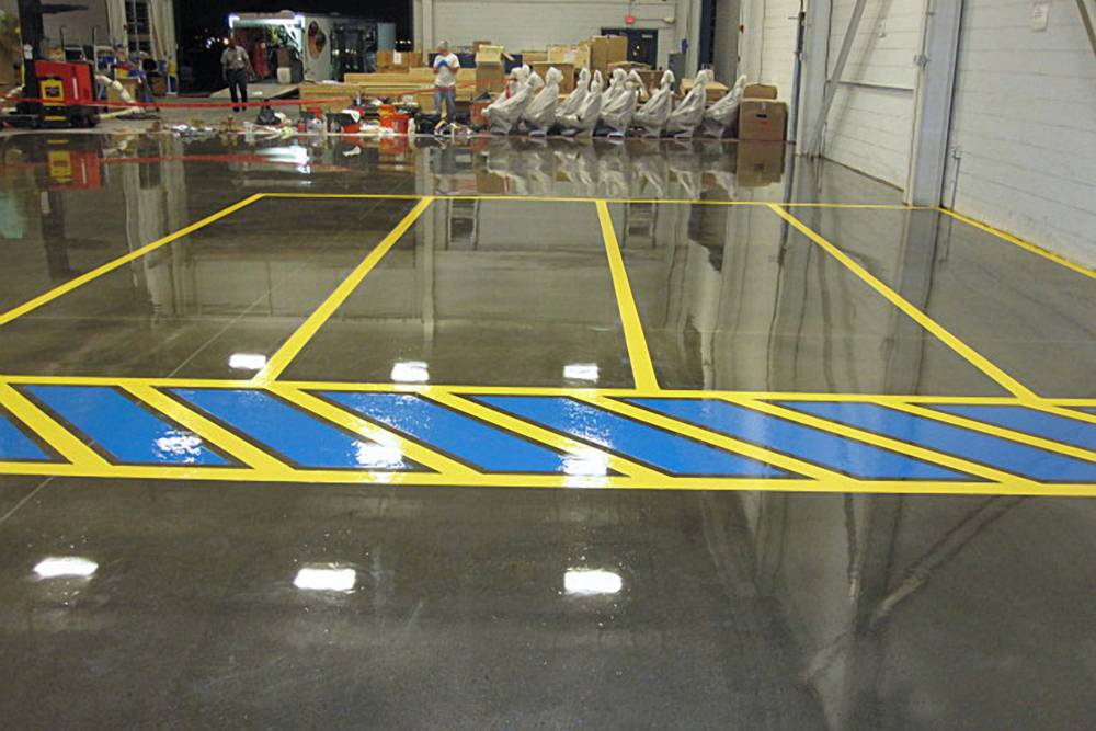 Clear epoxy floor coating provides protection against traffic wear in this shipping area.