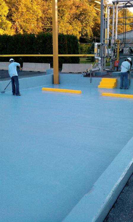 Anti-slip aggregate was broadcast into the system. Here the final top coat is applied.