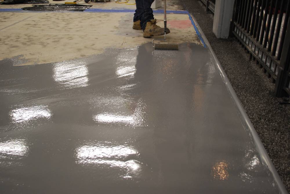 Epoxy floor coating is applied after surface prep is completed.